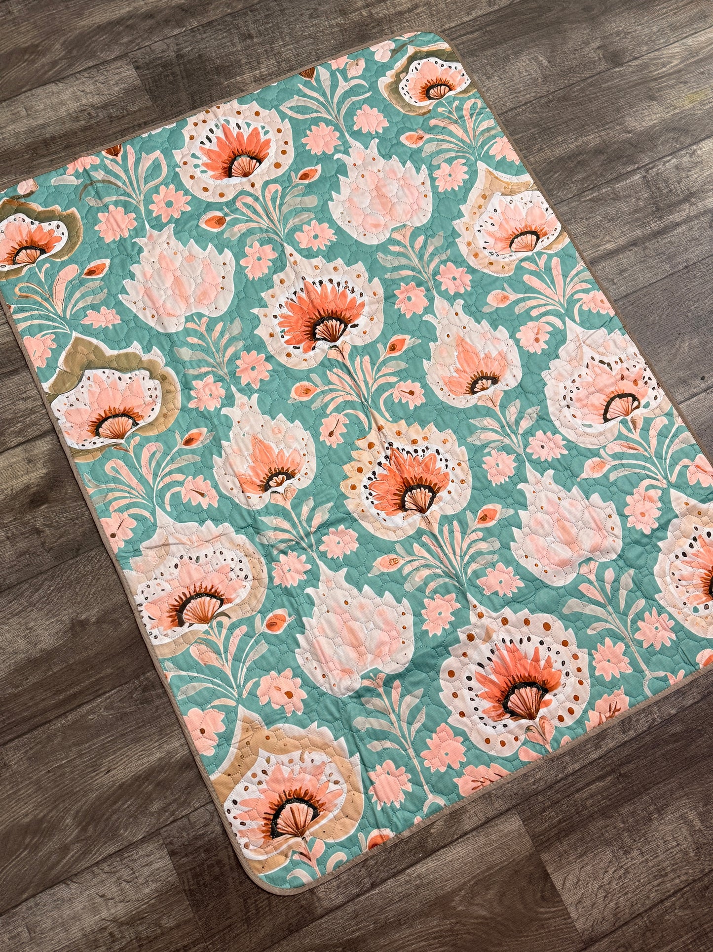 Floral patterned rug on a wooden floor
